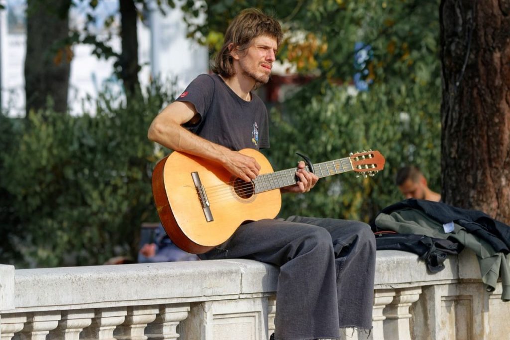 man singing with a guitar